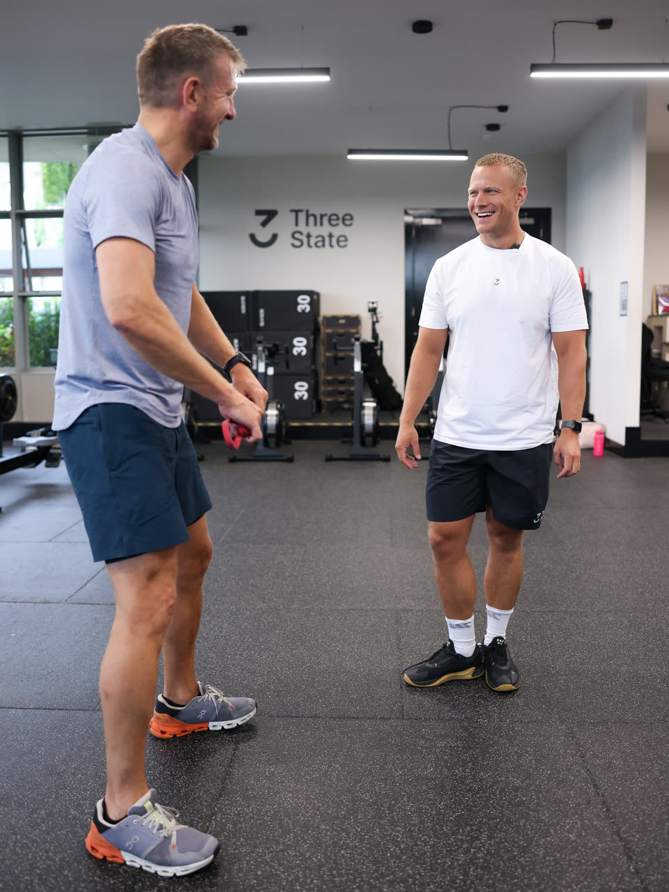 A coach talking a member through their assessment at Three State