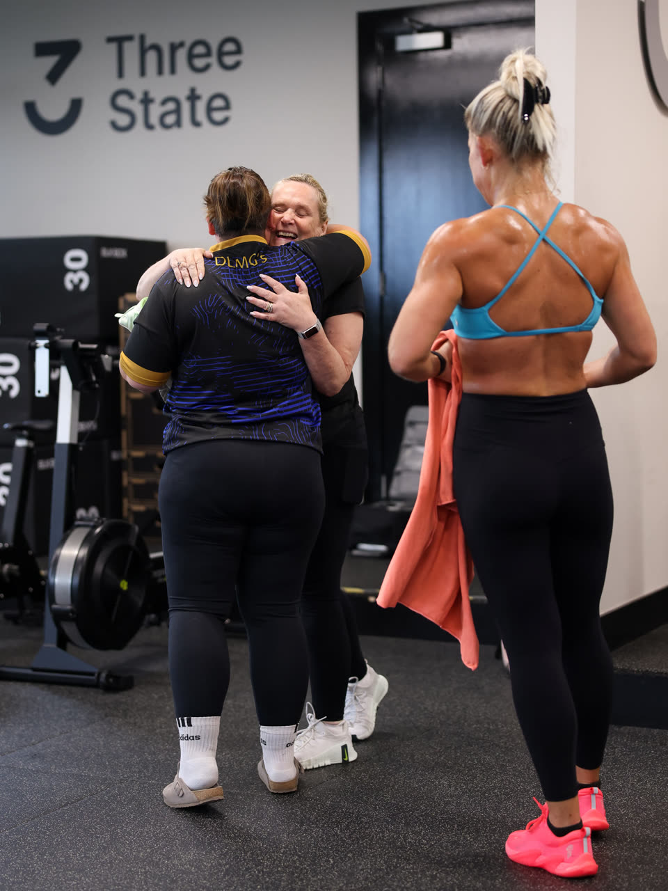 Two members sharing a hug after a session