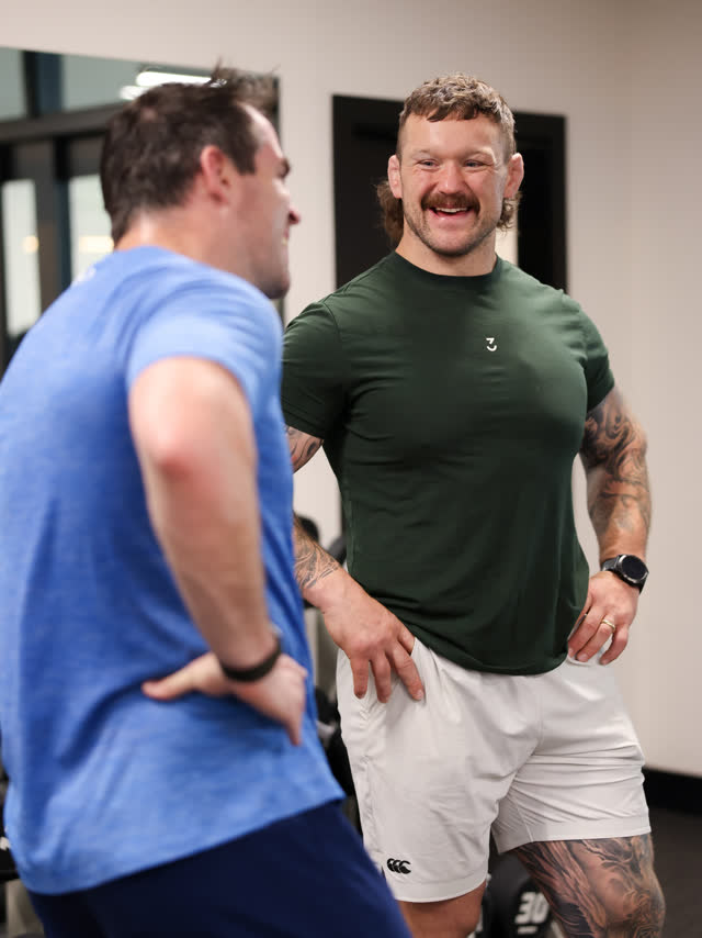 Andrew laughing with members on the floor