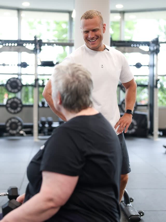 A coach sharing a laugh with a member